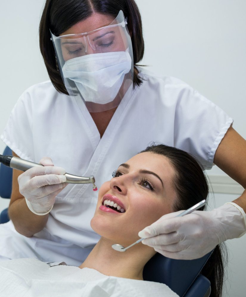 dentist-examining-female-patient-with-tools-e1698229146637